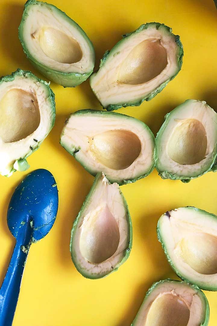 how to process step removing avocado half from skin with spoon.