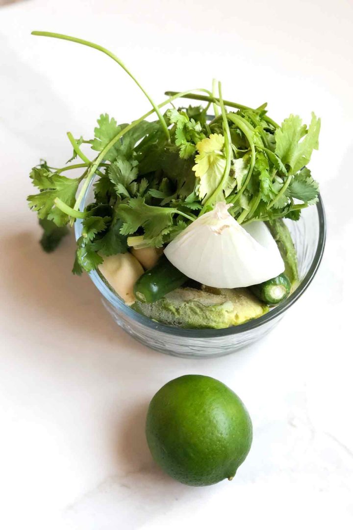 Step process to make easy Guacamole Salsa, all ingredients in a bowl.