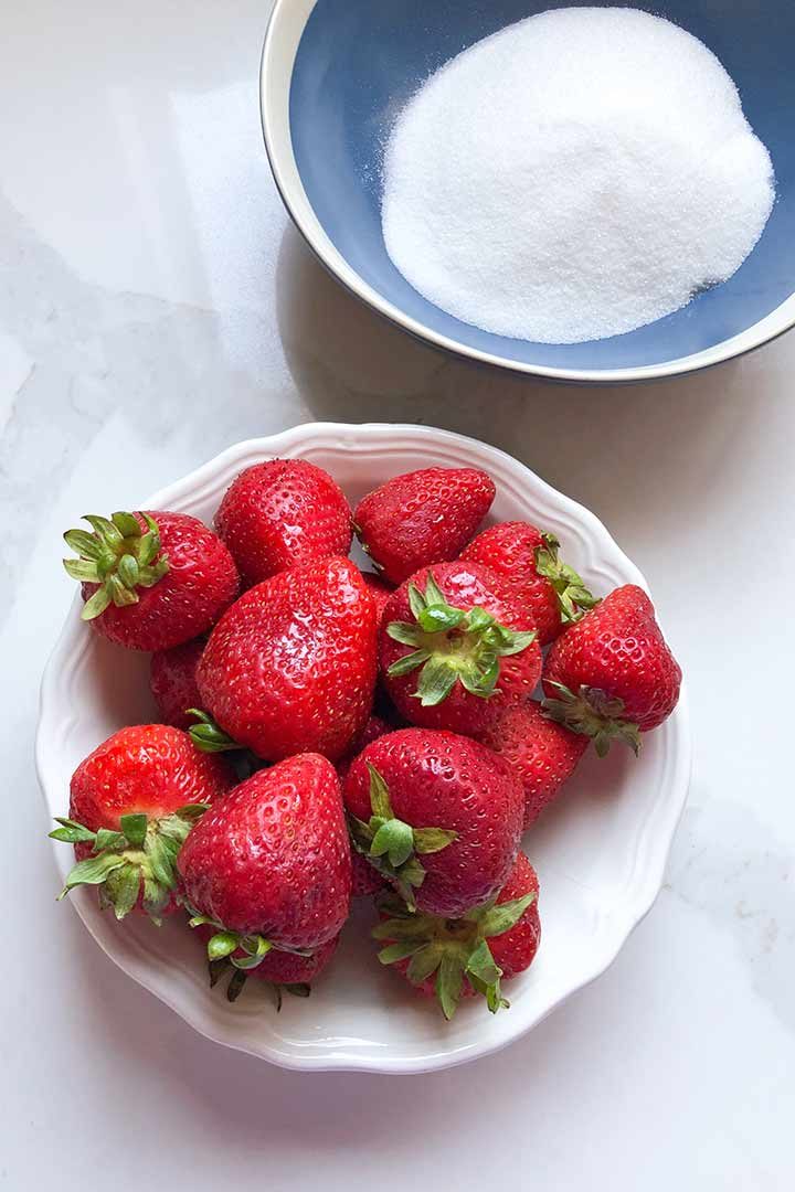 Ingredients to make Agua De Fresa, strawberry water. Strawberries, and sugar.