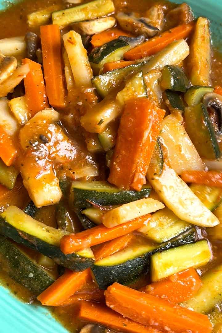 Upclose cooked vegetables in tomato sauce after slightly cooling.