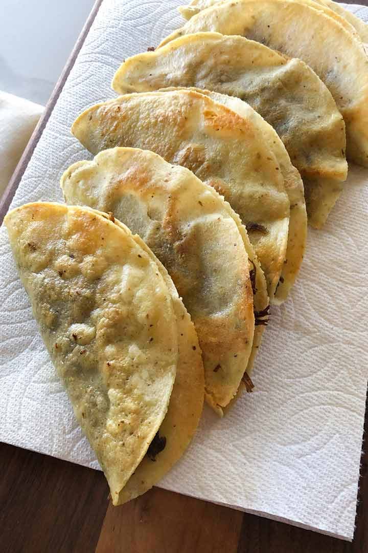 Crispy hard shell Mexican Beef Classic Tacos cooling on a paper towel to keep crisp.