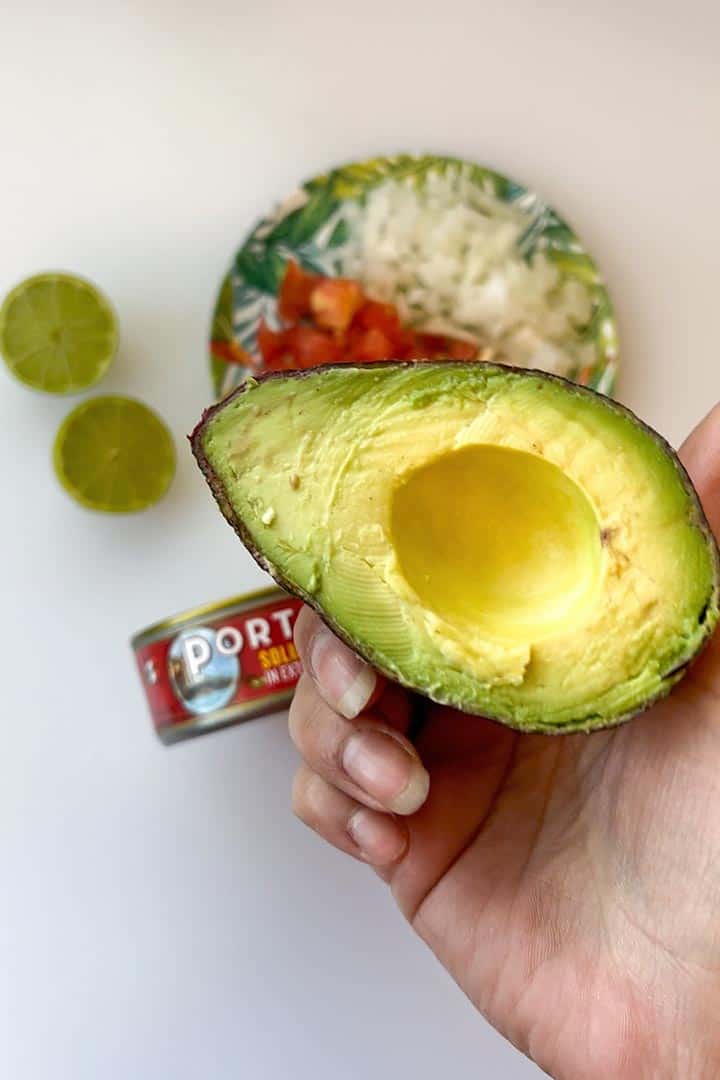 hand-holding-up-ripe-avocado-topping-option.