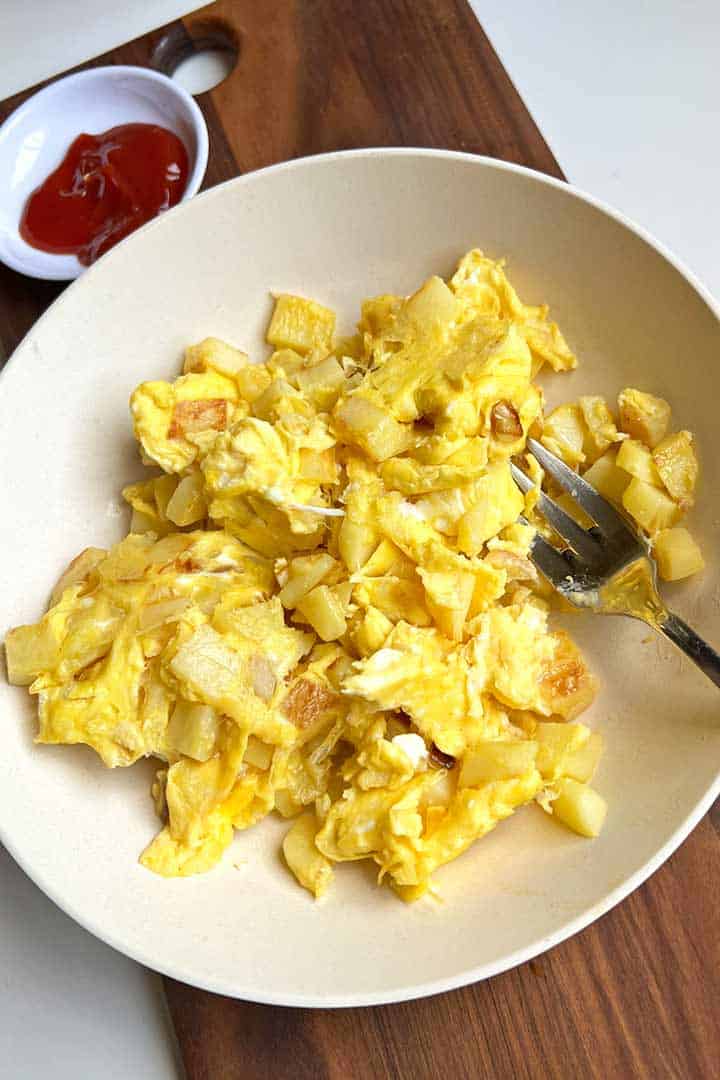 Transfer eggs and potatoes to clean plate.