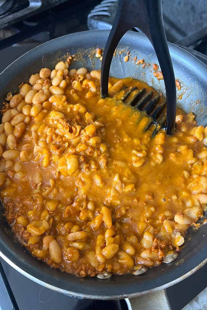 closeup of mashing chorizo beans.