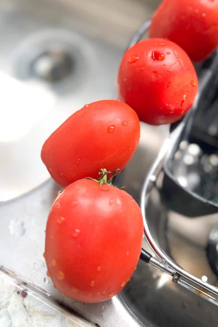 Salsa recipe roma tomatoes lined up after washing skins well.