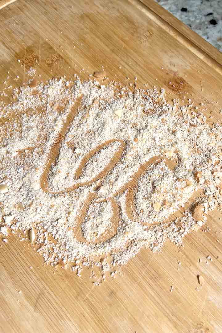 breadcrumbs on wood board with letters l-q-c in cursive.