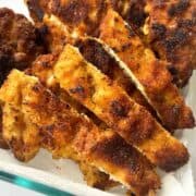 Chicken Milanesa recipe in glass kitchen storage.