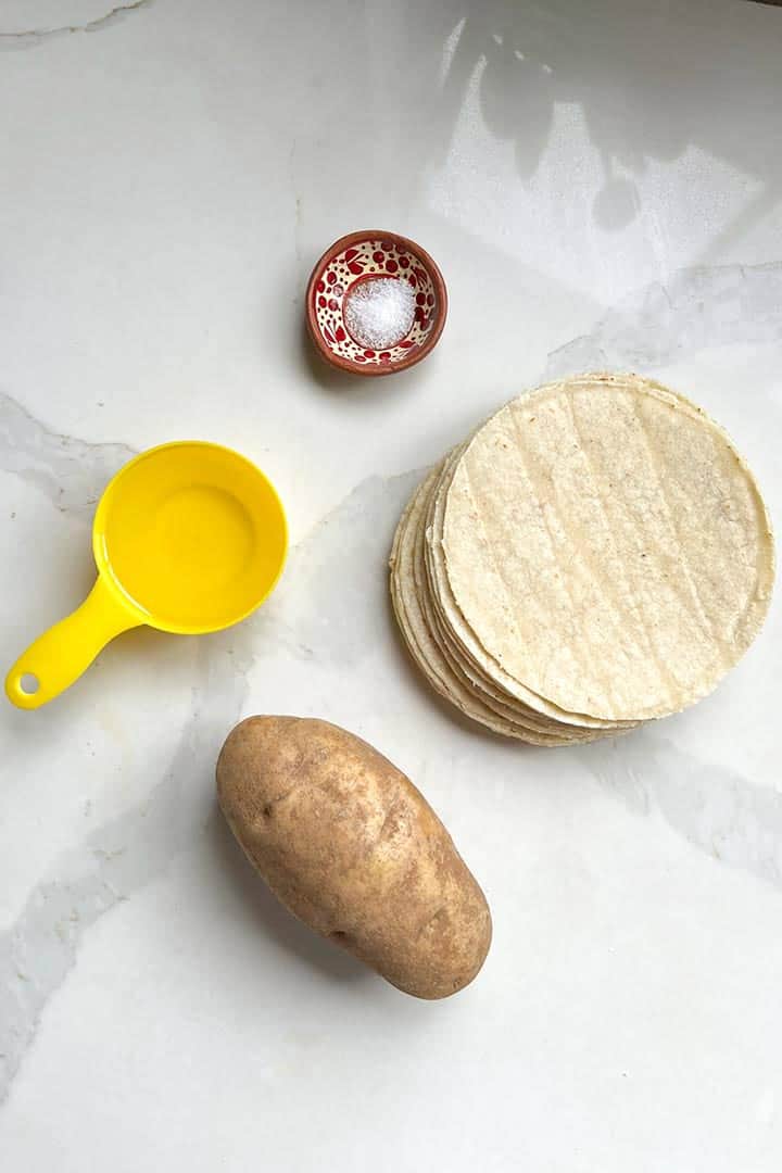 Ingredients to make Mexican crispy potato tacos: potato, fresh tortillas, neutral oil, and sea salt.
