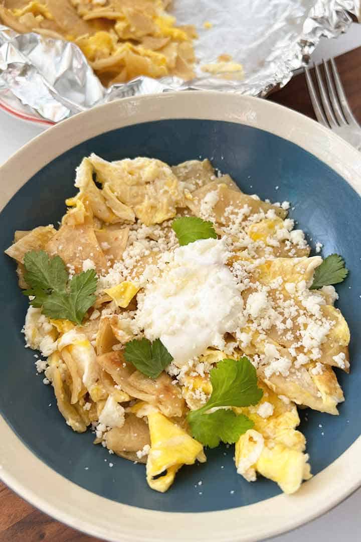 Cooked recipe in centered overhead photo of Eggs with Tortilla Scramble with toppings.