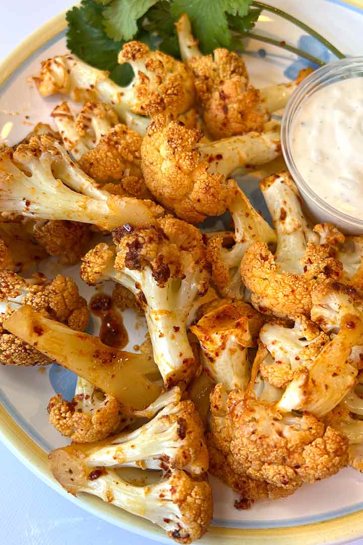 Best-Roasted-Buffalo-Cauliflower-appetizer-with-ranch-on-a-plate.