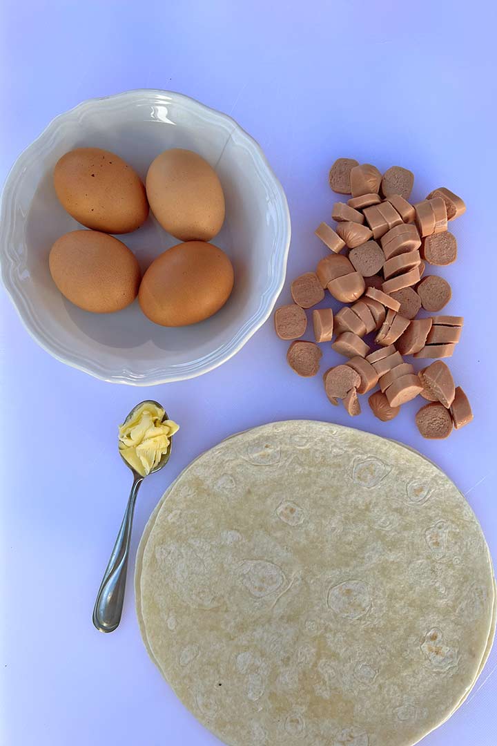 Ingredients in the recipe: eggs, slicedhotdogs, butter, and tortilas.