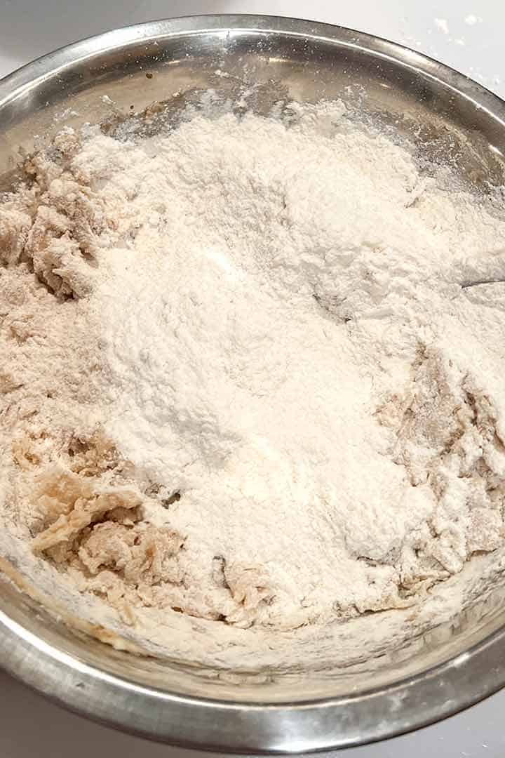 second half of flour on top of the batter to make mexican wed cookie-dough.