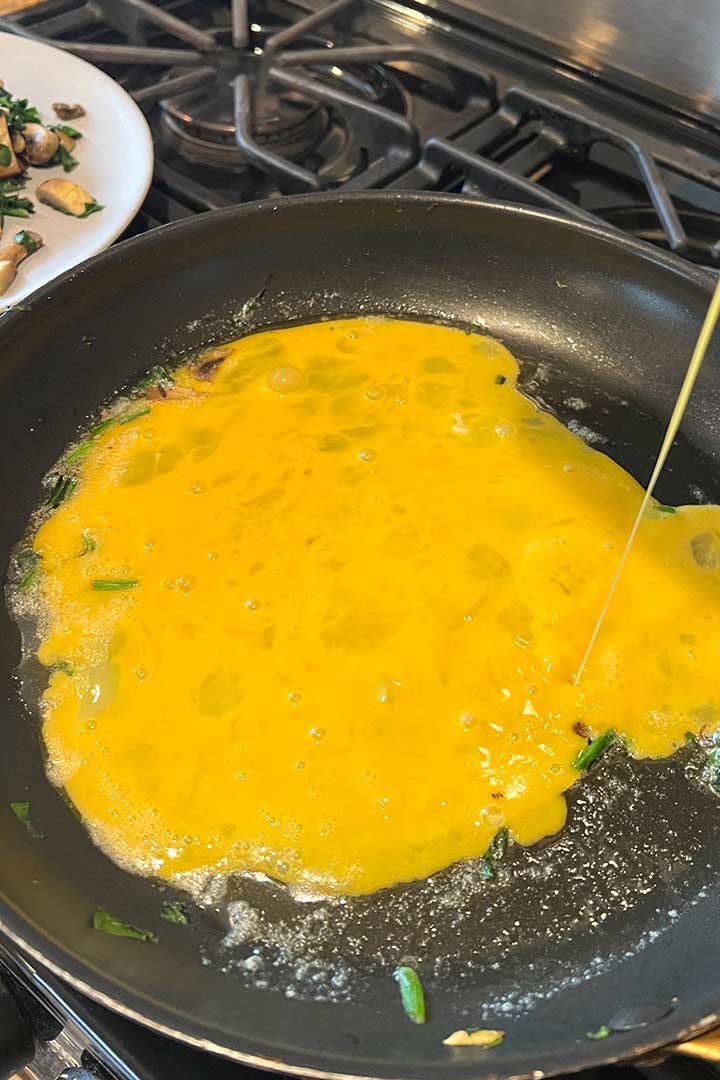 Egg mixture poured into hot pan for omelete.