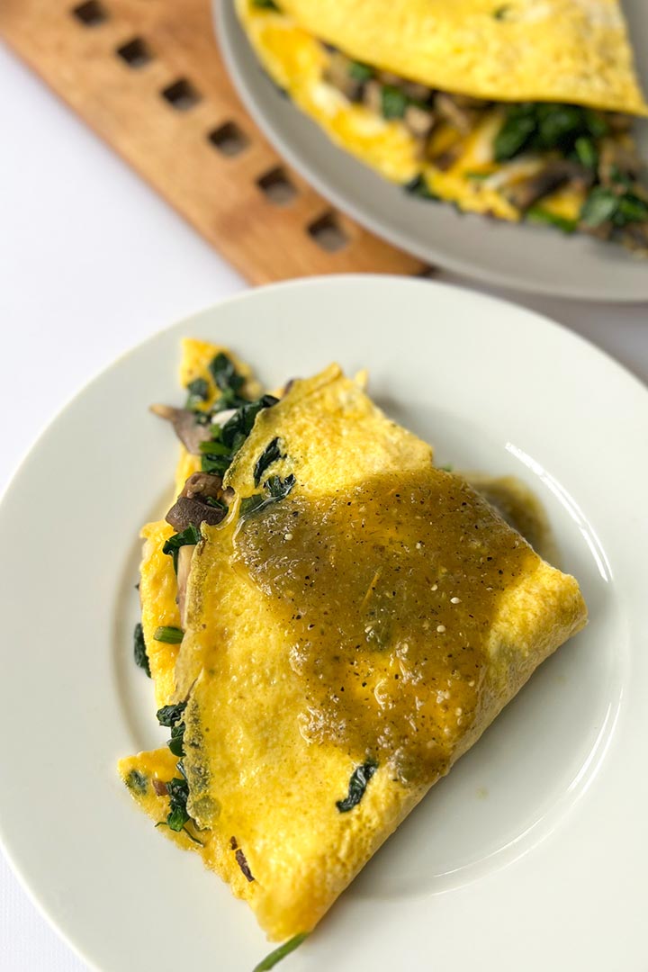 Omelette recipe end-piece with homemade salsa verde on top and more omelette in the background.