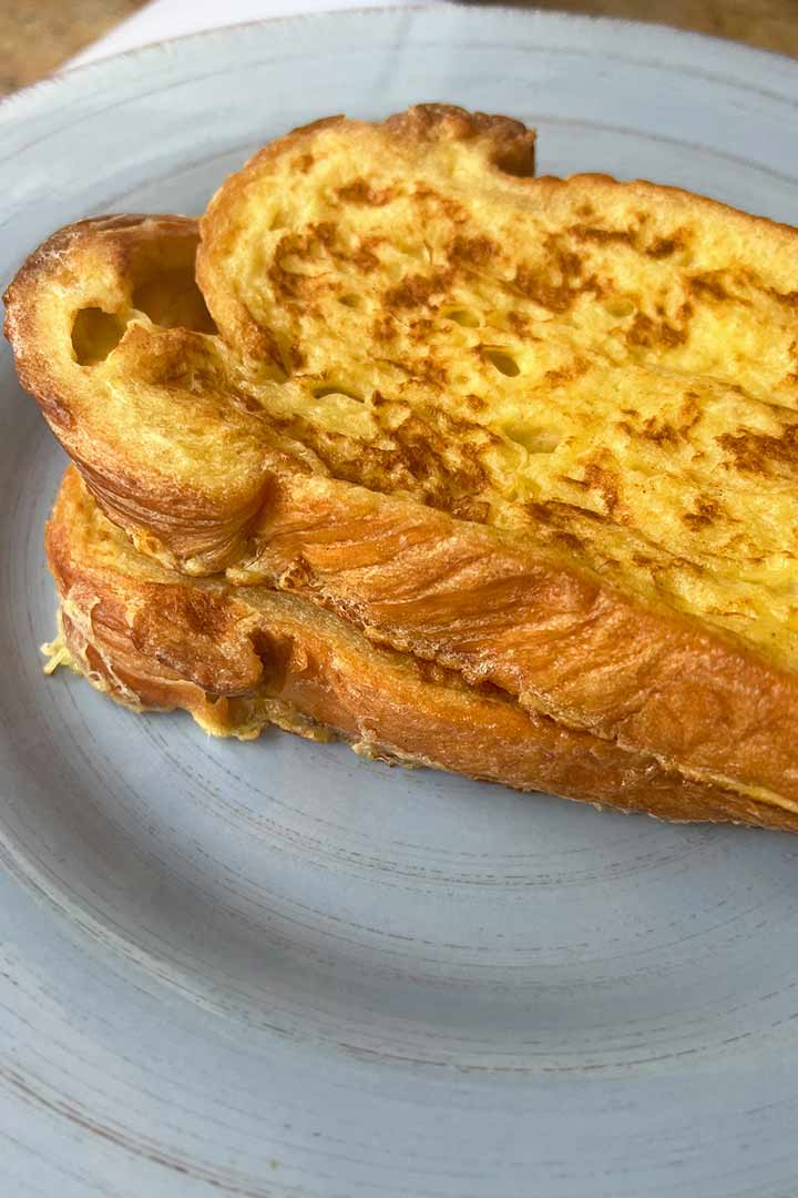 Two piece Freshly cooked french toast on plate.